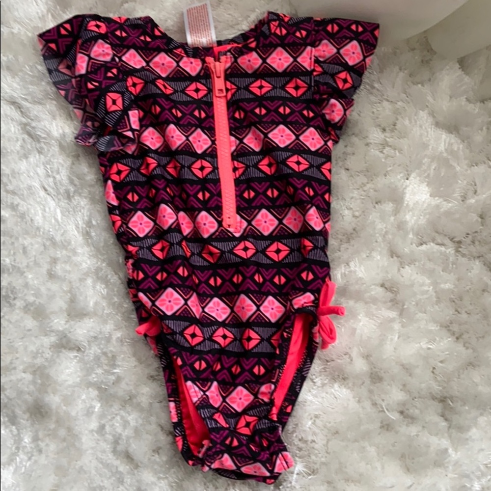 One piece. Rash guard bathing suit.